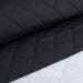 Black quilted fabric on a white grid background
