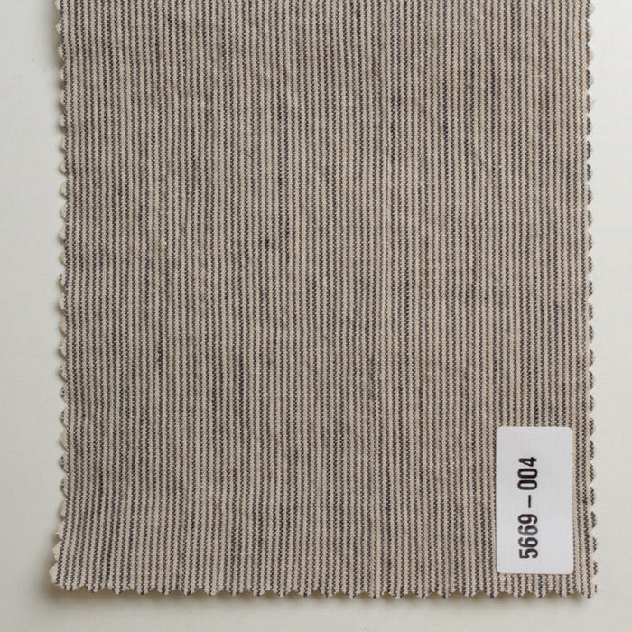 Textured fabric swatch with a label on a light gray background