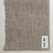 Textured fabric swatch with a label on a light gray background